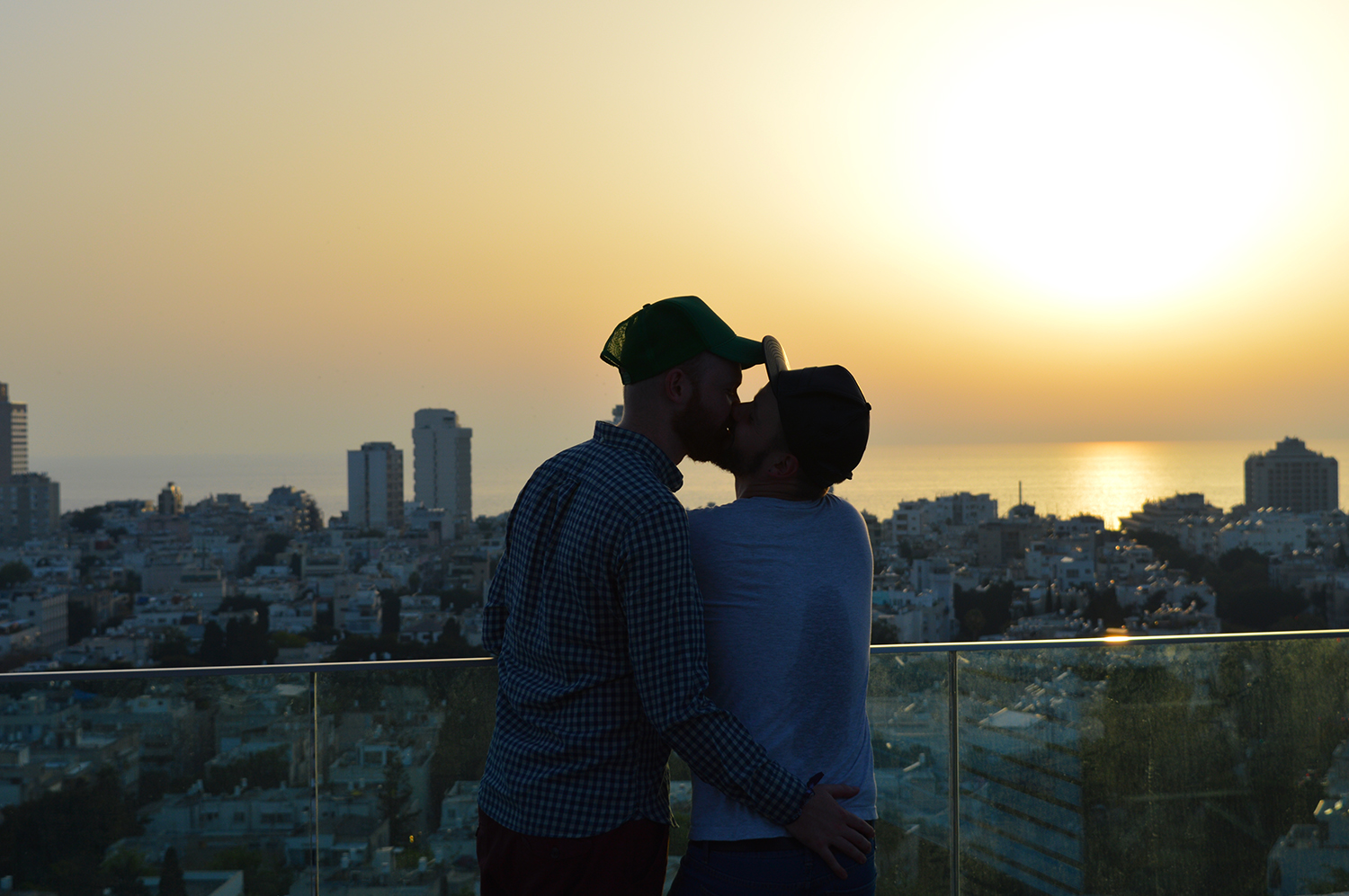 Gay Couple gay men kiss sun set beach Gay Pride Week Tel Aviv Israel 2016