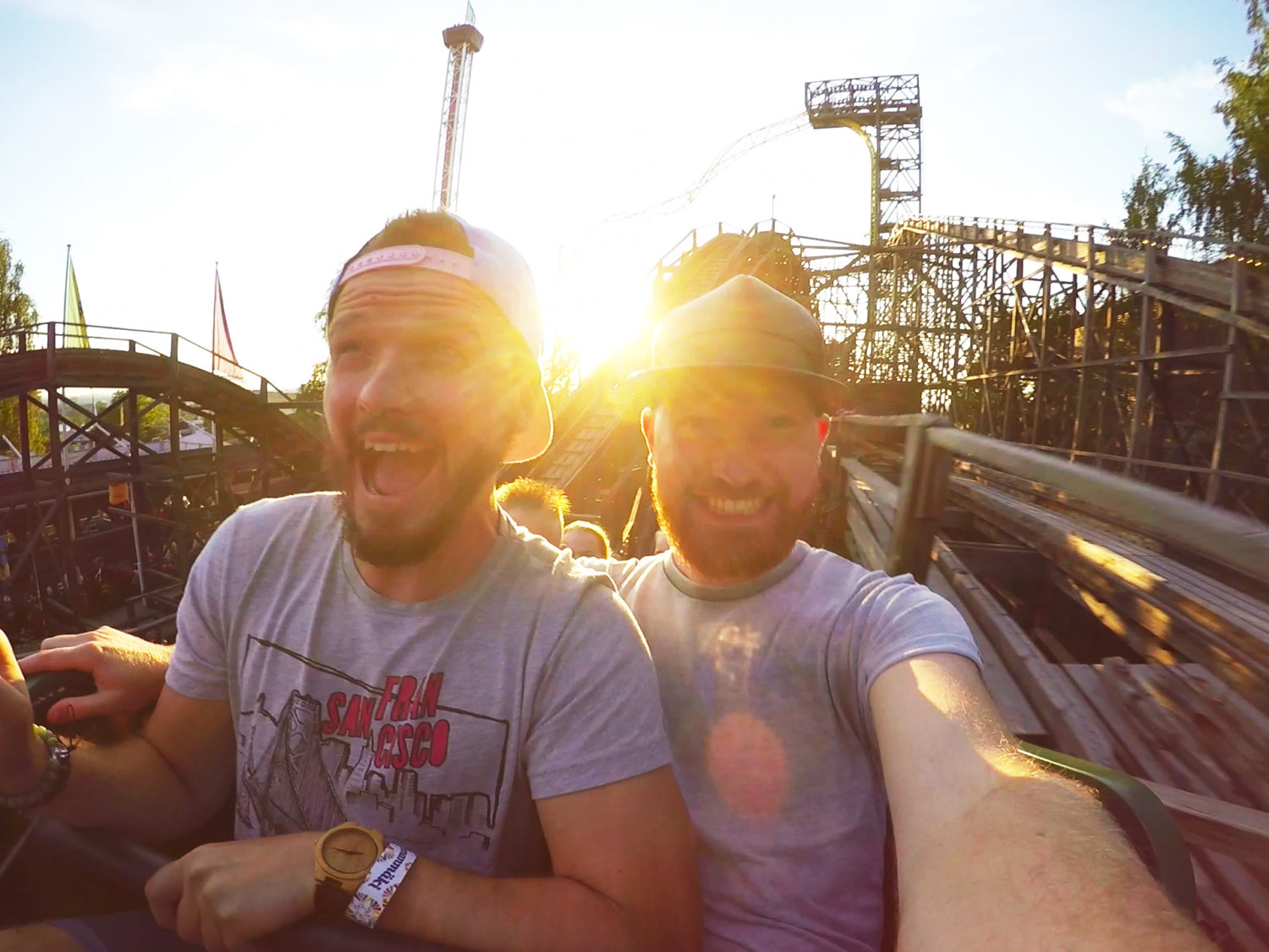 Gay Travel blogger Karl & Daan riding wooden roller coaster “Vuoristorata” | Our Gay Couple Review Theme Park Linnanmäki Helsinki Finland © Coupleofmen.com