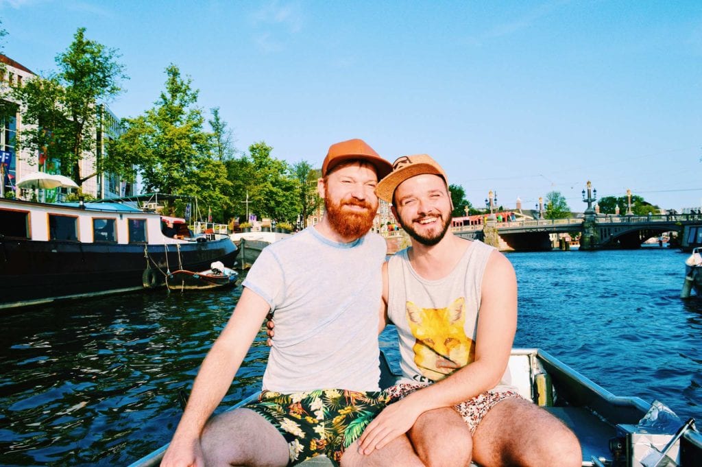 Karl & Daan driving their own rental boat in Amsterdam | Gay Couple Rental Canal Boat Tour Amsterdam Boats4rent © CoupleofMen.com