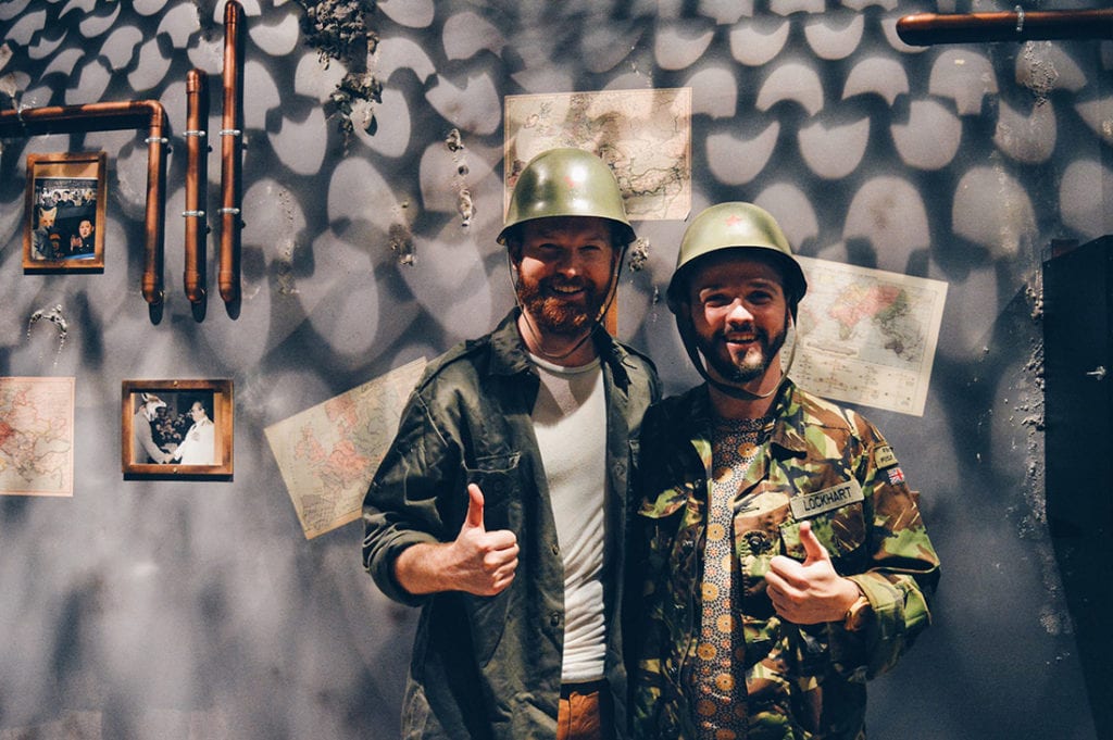 two gay guys in army clothes after winning the Escape Room "Bunker" from Fox in a Box © CoupleofMen.com