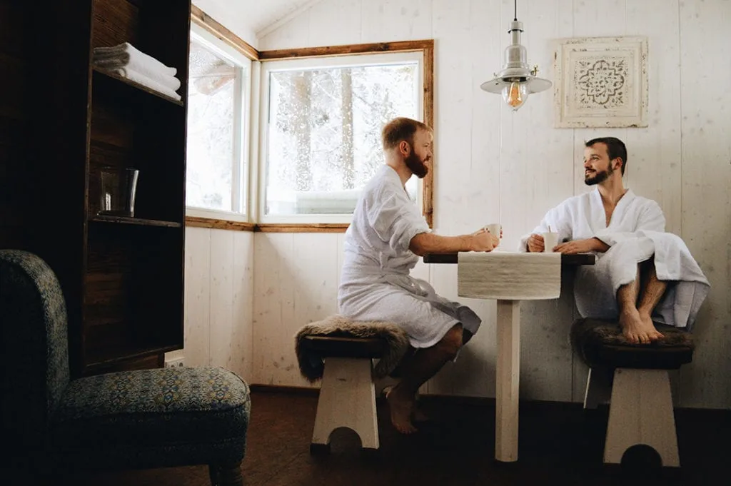 two gay men dirnking tea coffee at sauna Slumber Wine Barrel Taufsteinhütte Central Germany © CoupleofMen.com