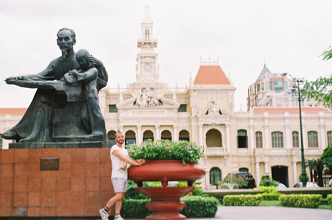 Schwul in Vietnam Karl in front of the Ho Chi Minh statue outside Ho Chi Minh City People's Committee | Top Highlights Best Photos Gay Couple Travel Vietnam © CoupleofMen.com