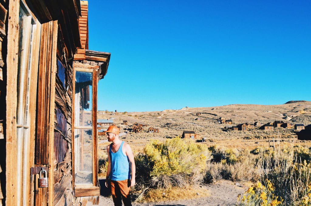 Daan exploring abandoned houses of the Wild West Town | Gay Couple Ghost Town Adventure Bodie California © CoupleofMen.com