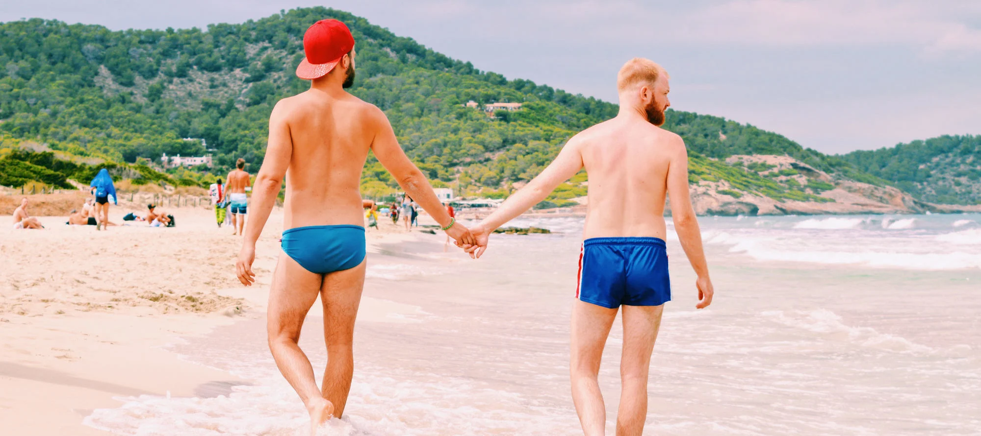 Gay Couple Travel Guides Spain Gay Travel Blogger hand in hand | Gay Couple Travel Gay Beach Ibiza Town Spain Spartacus Gay Travel Index 2019 © CoupleofMen.com