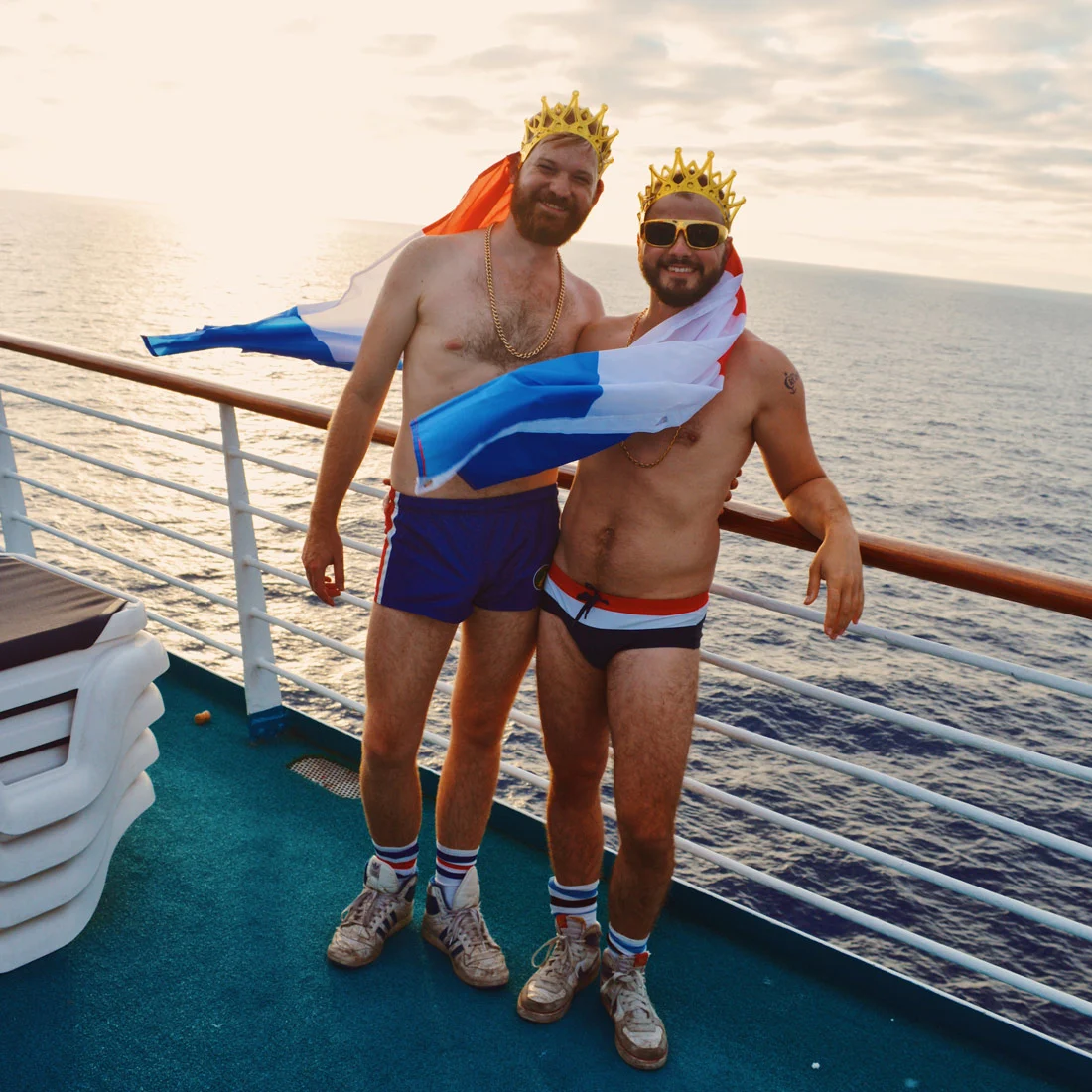 Karl / Daan with Dutch flags, crowns, and the sunset © CoupleofMen.com