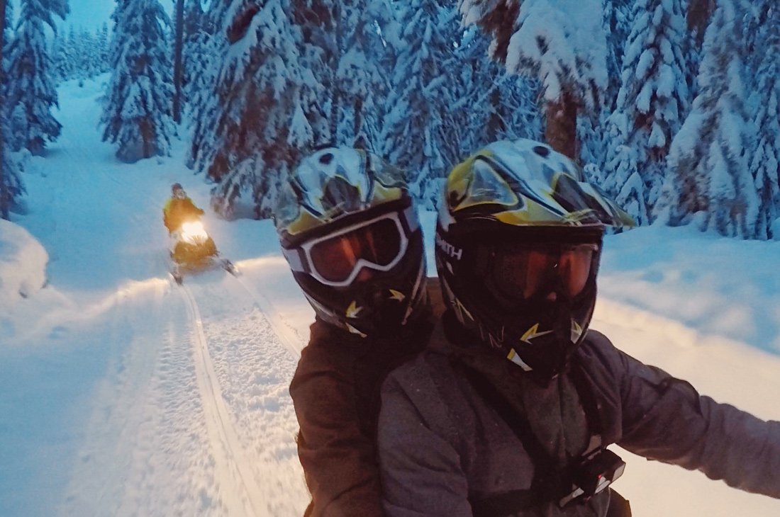 Hand-in-hand and arm-in-arm on a snowmobile | Zip Lining Snowmobiling TAG Whistler Gay-friendly © Coupleofmen.com