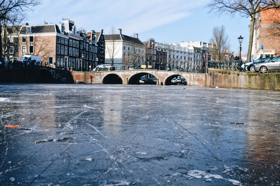 Winter on Amsterdam's Frozen Canals Thick Ice of the Frozen Canals in Amsterdam | Amsterdam Frozen Canals © Coupleofmen.com