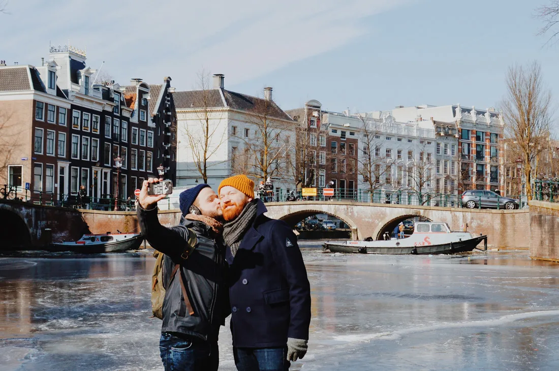 Winter on Amsterdam's Frozen Canals A Gay Kiss Selfie on the ice of the Keizersgracht | Amsterdam Frozen Canals © Coupleofmen.com