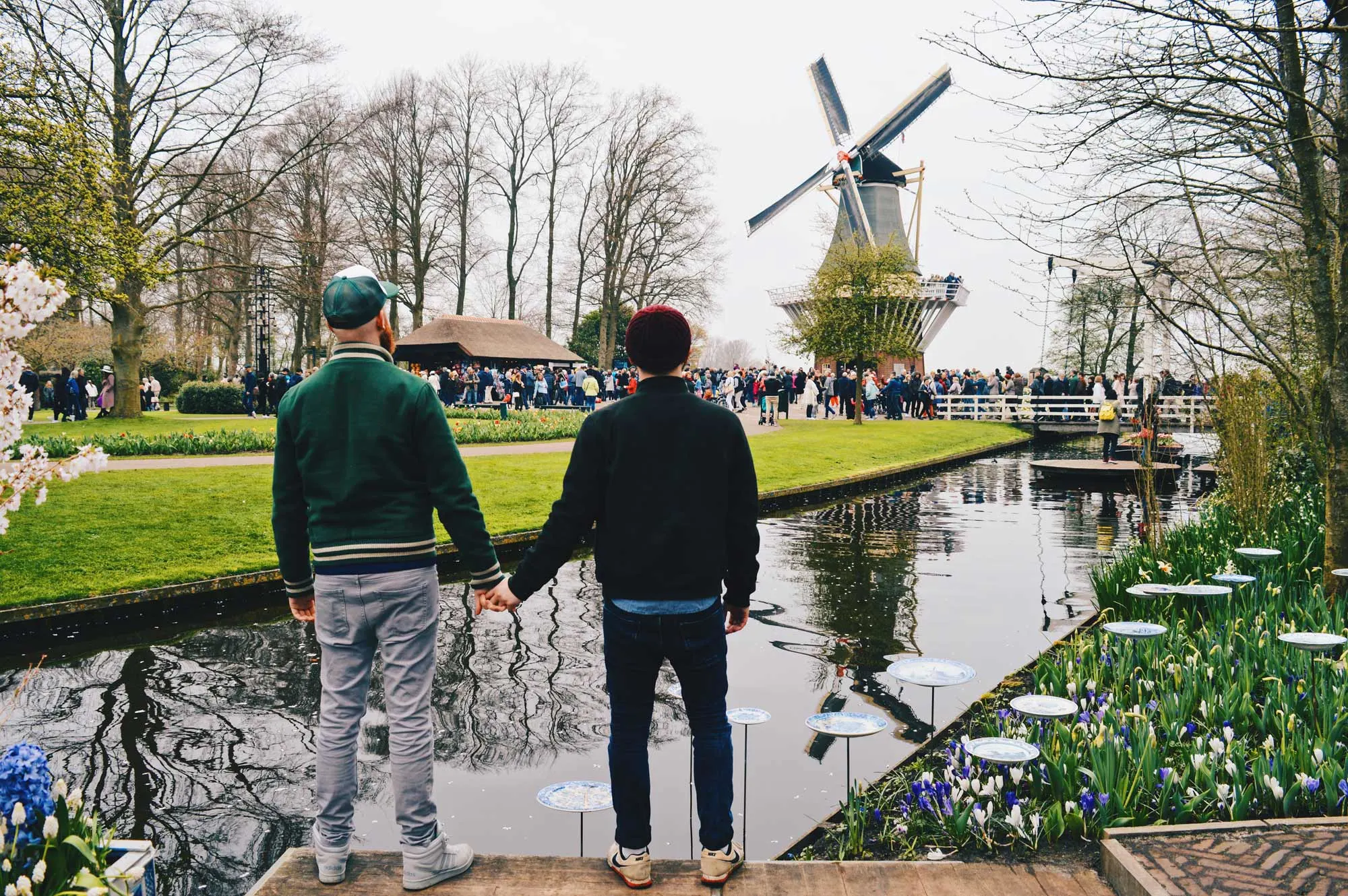 Gay Travel bloggers Couple of Men hand-hand Tulip fields, a windmill, and two gay men hand-in-hand: See you soon! | Keukenhof Tulip Blossom Holland © Coupleofmen.com