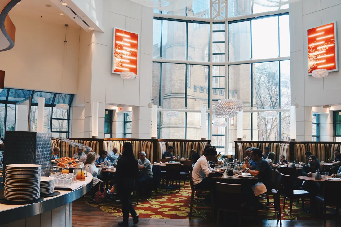 Huge breakfast room with a view of the Church of the Holy Trinity | Marriott Downtown Toronto Toronto Eaton Centre © Coupleofmen.com