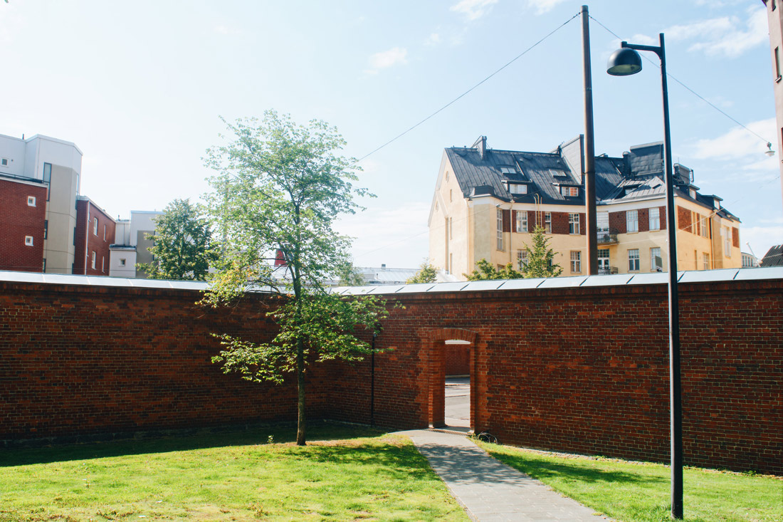 Well maintained prison garden always surrounded by the omnipresent brick wall | Katajanokka Hotel Helsinki Gay-friendly Review © Coupleofmen.com