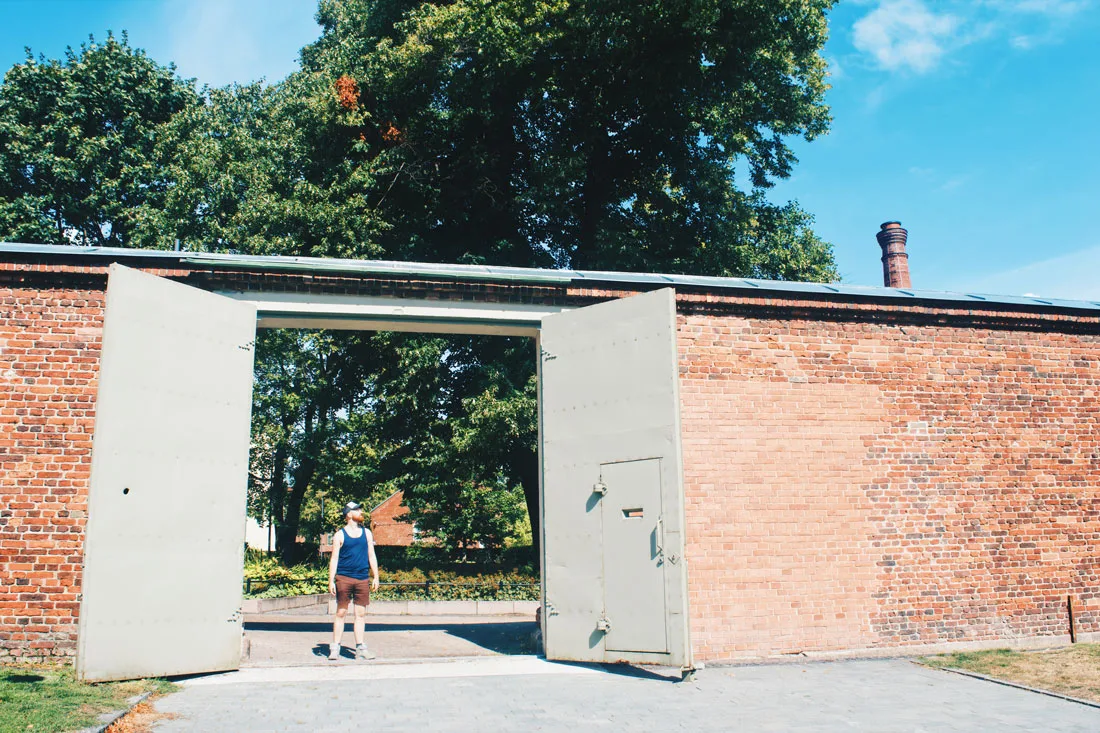 Daan standing in one of the prison gates | Katajanokka Hotel Helsinki Gay-friendly Review © Coupleofmen.com