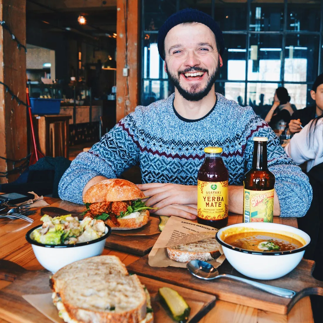 Karl is happy about his breakfast & Coffee at Simmons building in Calgary | Winter Road Trip Alberta Highlights Canadian Rocky Mountains © Coupleofmen.com