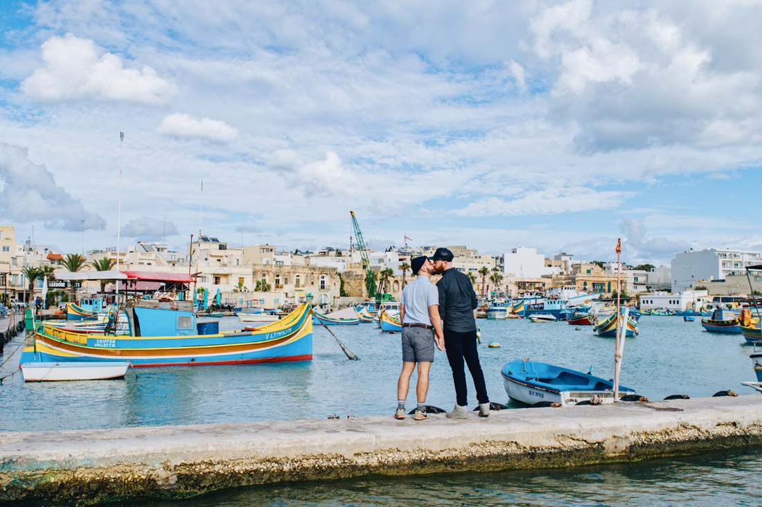 EuroPride 2023 Malta A gay kiss in fron of a traditional Maltese Boat in Marsaxlokk © Coupleofmen.com