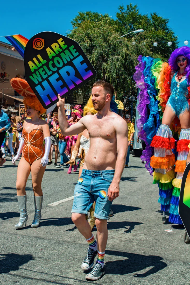 'All are welcome here' at Los Angeles Pride in West Hollywood even as half naked sex man in jeans © Coupleofmen.com