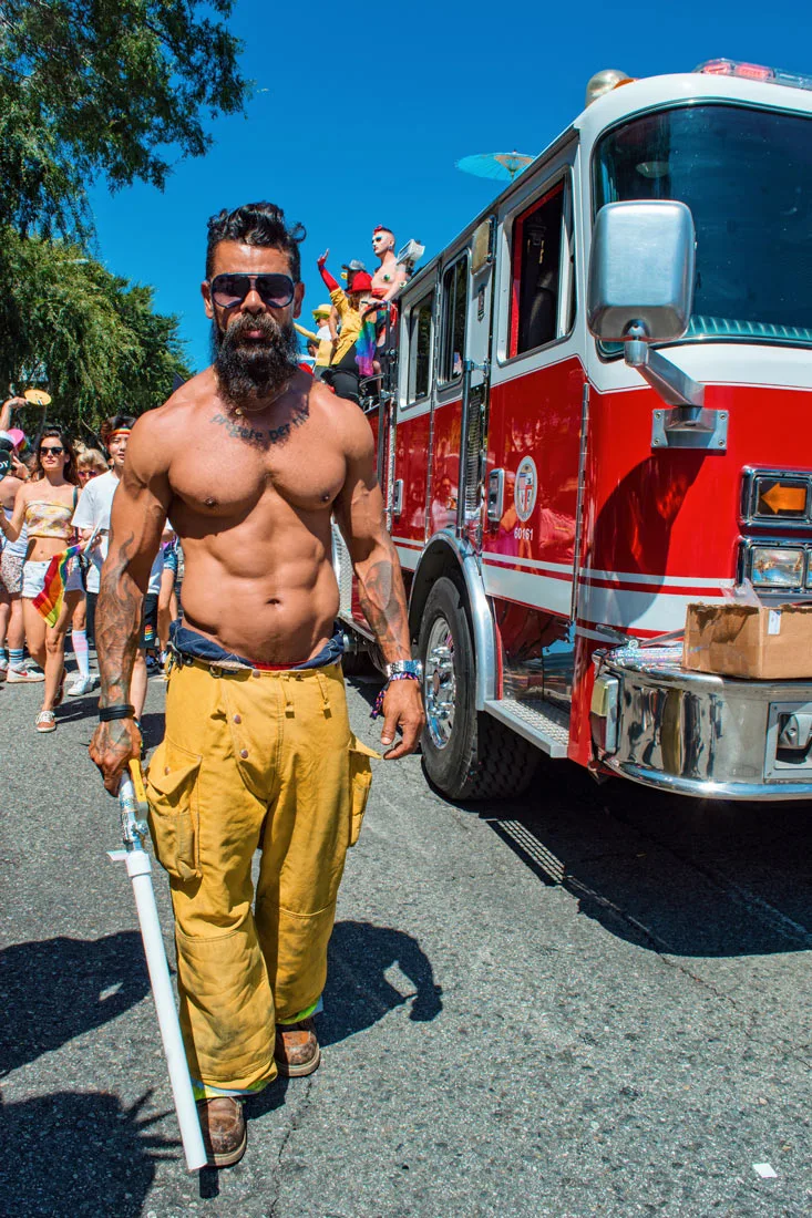 half naked man red fire department car blue sky at LA Pride in West Hollywood