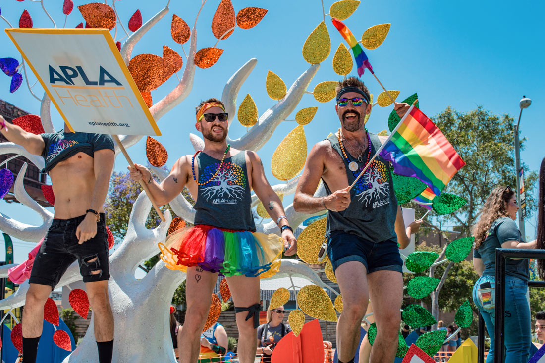 Handsome men in shorts, Tutu and with rainbow flags on a float at LA Pride 2019 © Coupleofmen.com