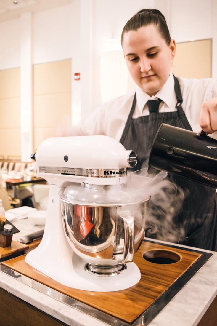 waiter creating table side ice cream with liquid nitrogen at the French cuisine restaurant Bocuse which is part of the Culinary Institute of America