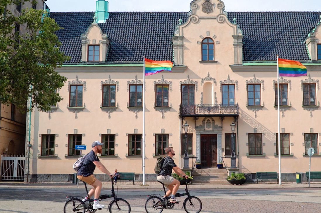 Malmö Gay City Trip South Sweden Biking around Malmö City with Rainbow Flag © Coupleofmen.com