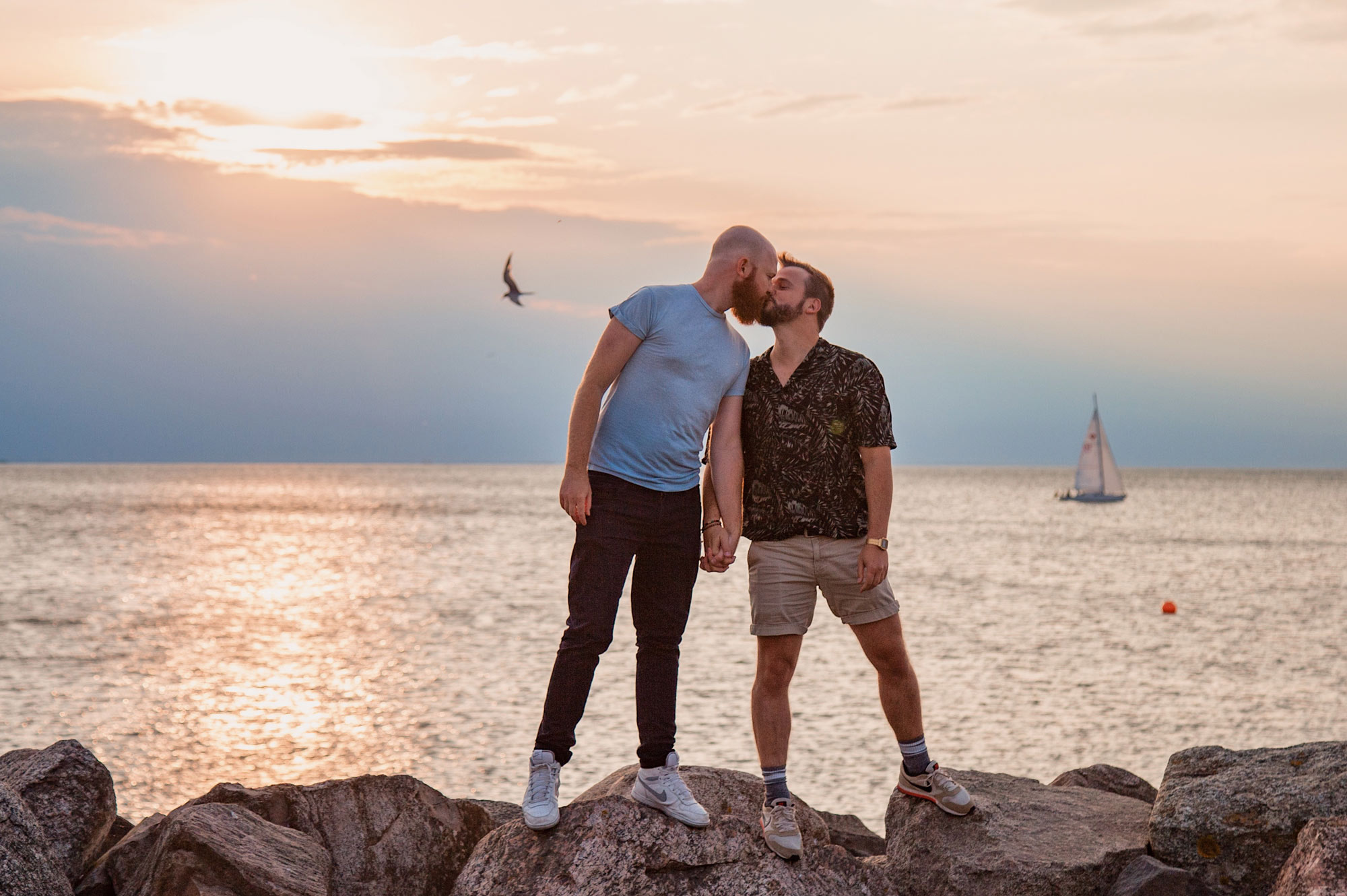LGBTQ+ Pride: Pride LGBTQ+ rights Movement Malmö Gay City Trip South Sweden A Gay Kiss during Sunset over the Baltic Sea © Coupleofmen.com/ Photo: Maartje Hensen