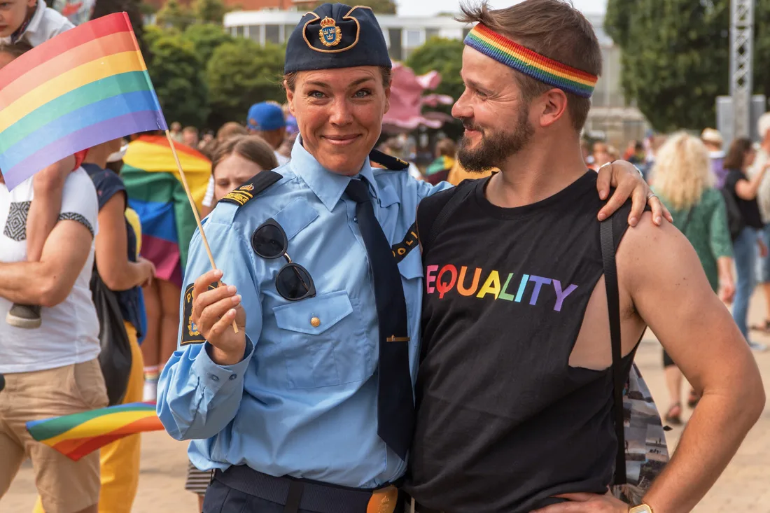 Gay Pride Malmö 2019 Karl posing with a proud police officer protecting the LGBTQ+ festival at Folkets Park Malmö © Coupleofmen.com
