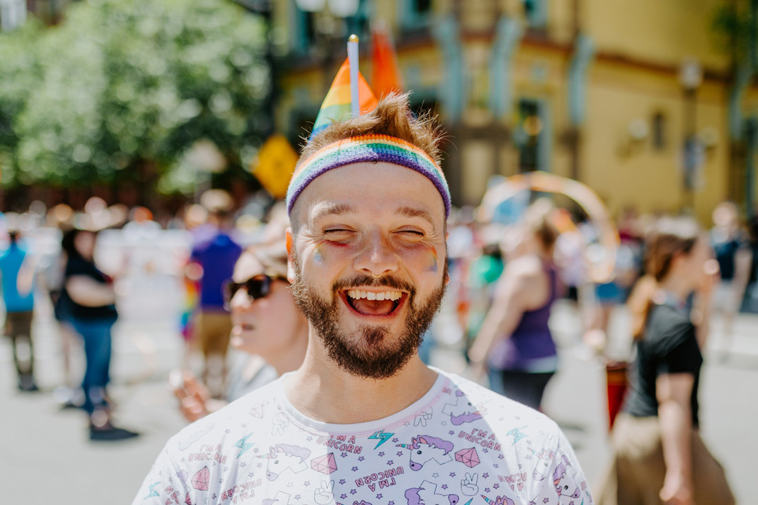 Karl dressed in his unicorn shirt with rainbow flags all over the place © Coupleofmen.com