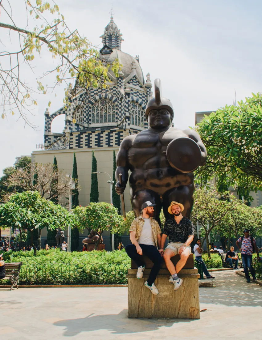 Taking a moment in the shadow of Botero's work in Medellín © Coupleofmen.com