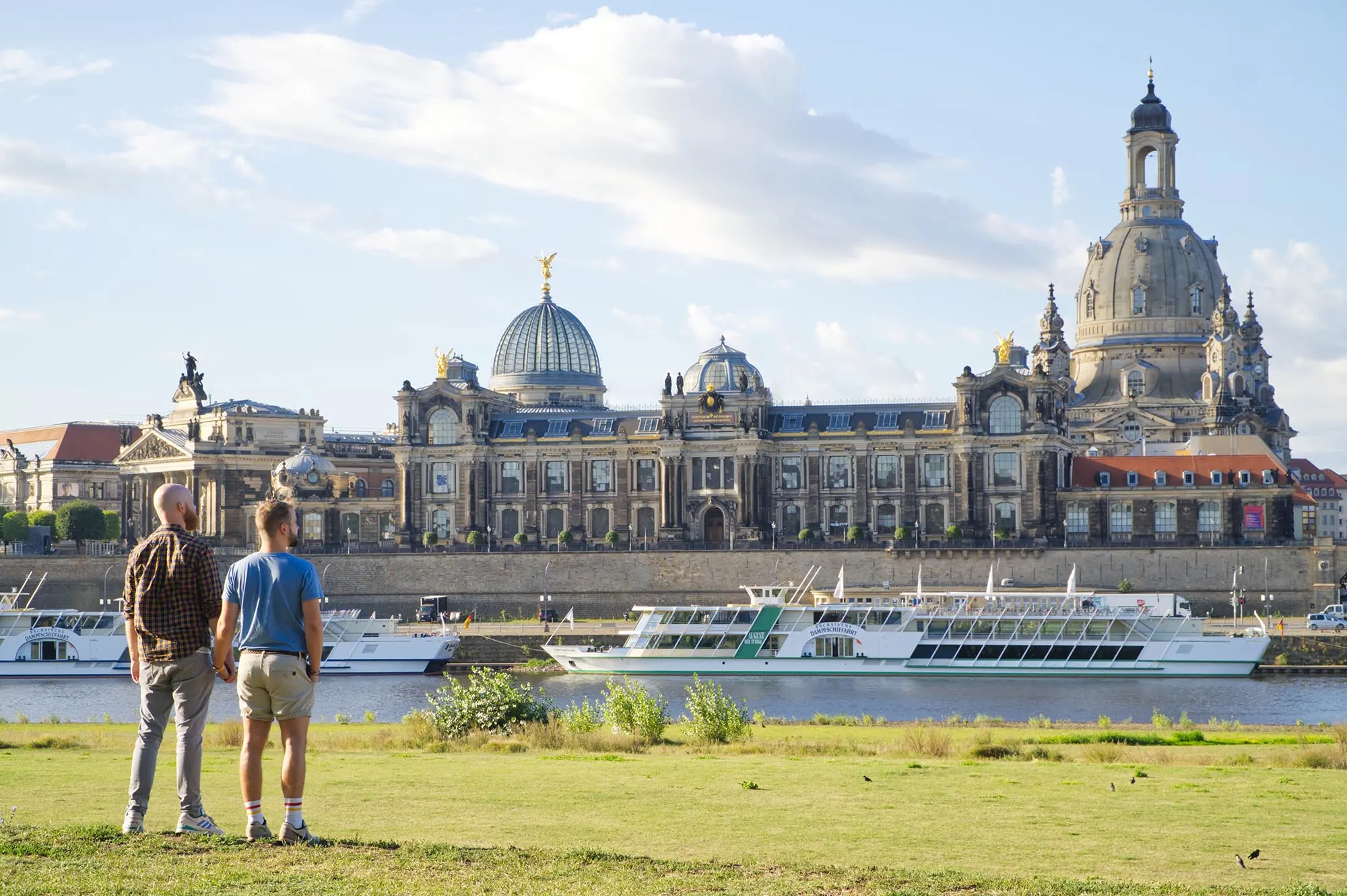 A Gay Couple hand-in-hand looking at the Dresden-Panorama and the River Elbe © Coupleofmen.com