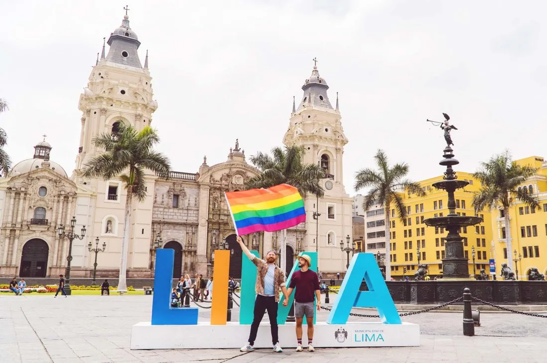 Proudly waving the rainbow flag in Lima Plaza Mayor © Coupleofmen.com