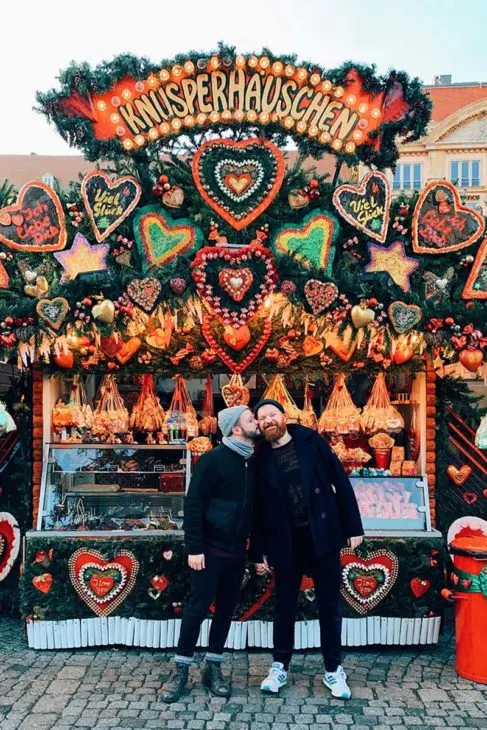 Gay Christmas Markets Gay Kiss in front of a Ginger Bread shop in Dresden Striezelmarkt © Coupleofmen.com