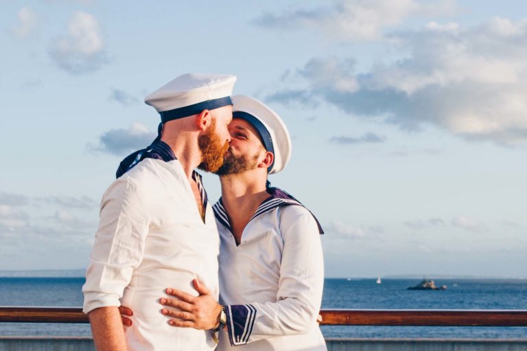 Kiss of two men dressed in sailor outfits on a gay cruise © Coupleofmen.com