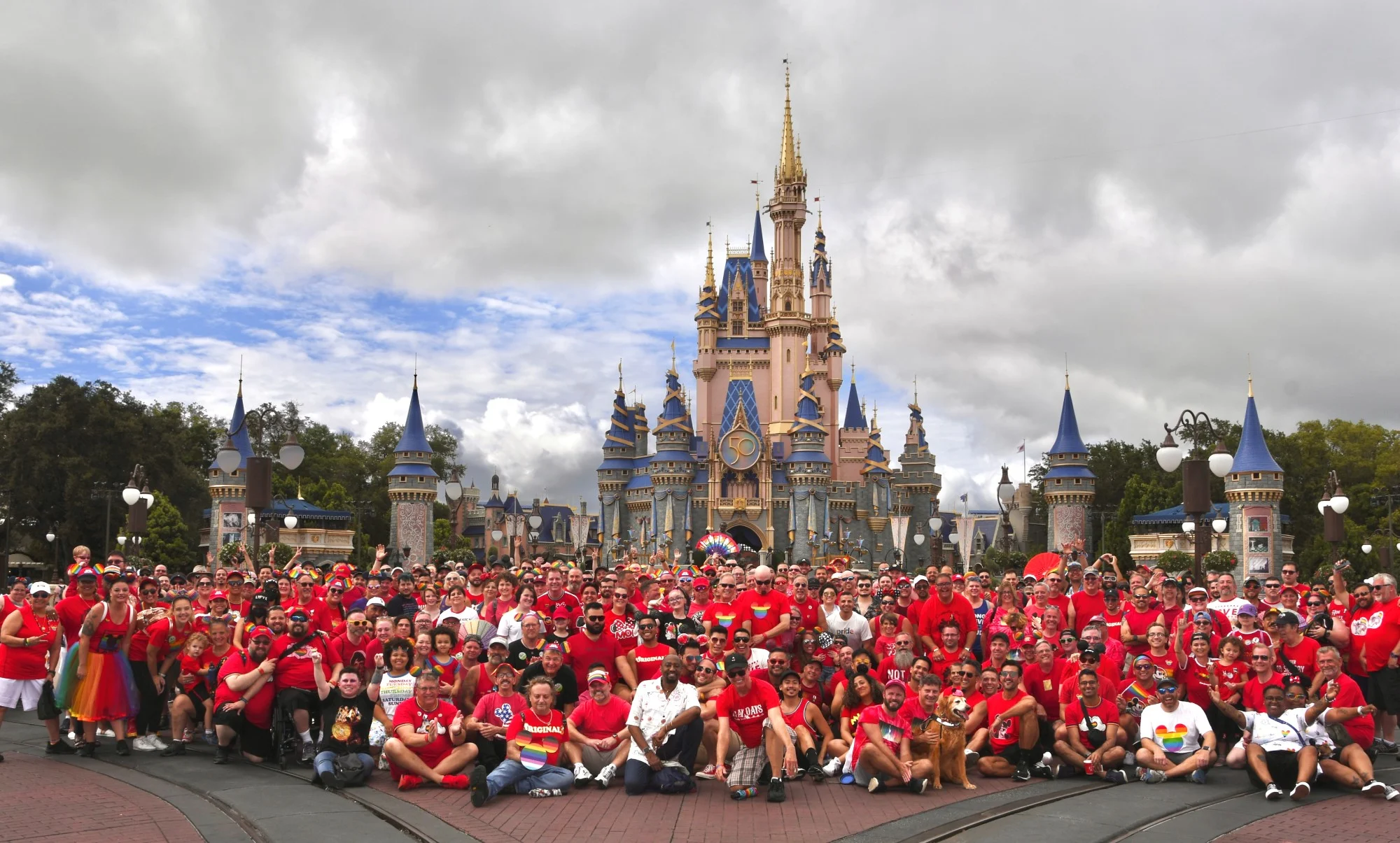 Disney Gay Days red shirt group picture in front of Cinderella Castle in Magic Kingdom Park at the Walt Disney World Resort in Orlando.