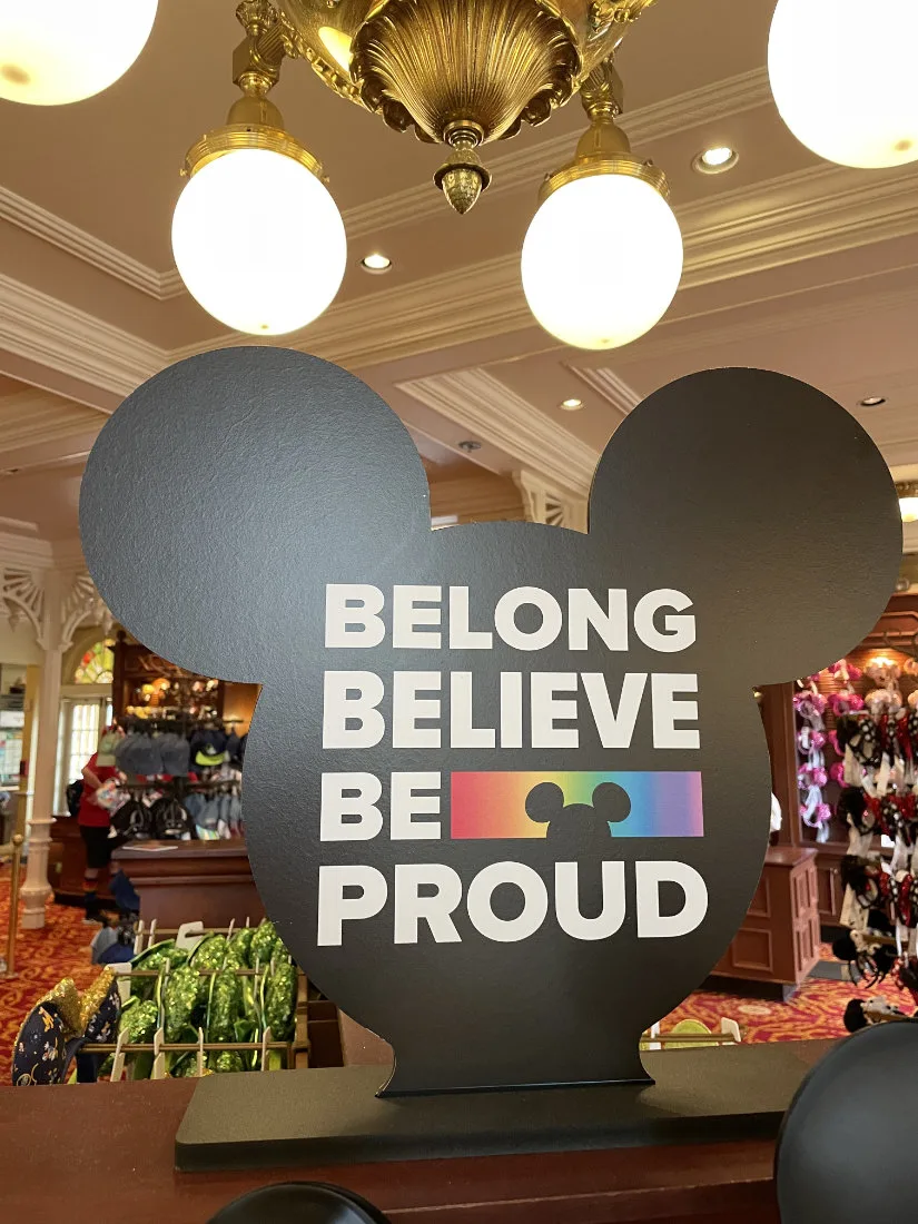 Disney Store Proud Collection sign reading Belong, Believe, Be proud.