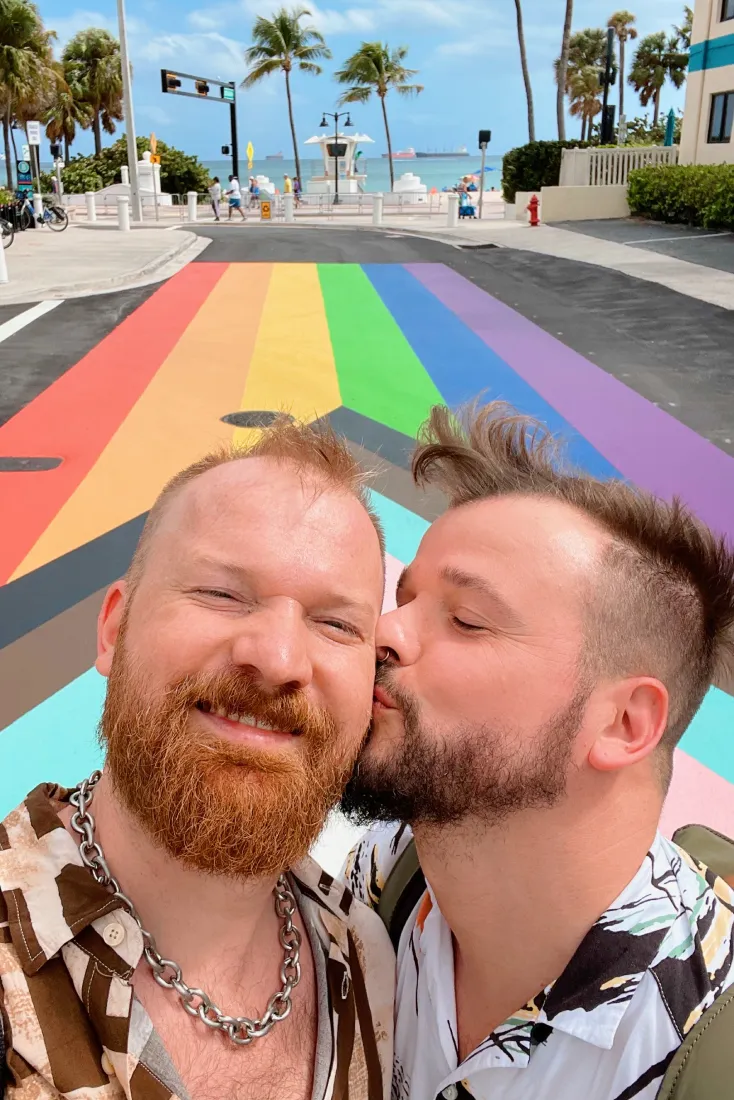 Kiss Selfie on the Rainbow Crosswalk in front of the Gay Beach © Coupleofmen.com