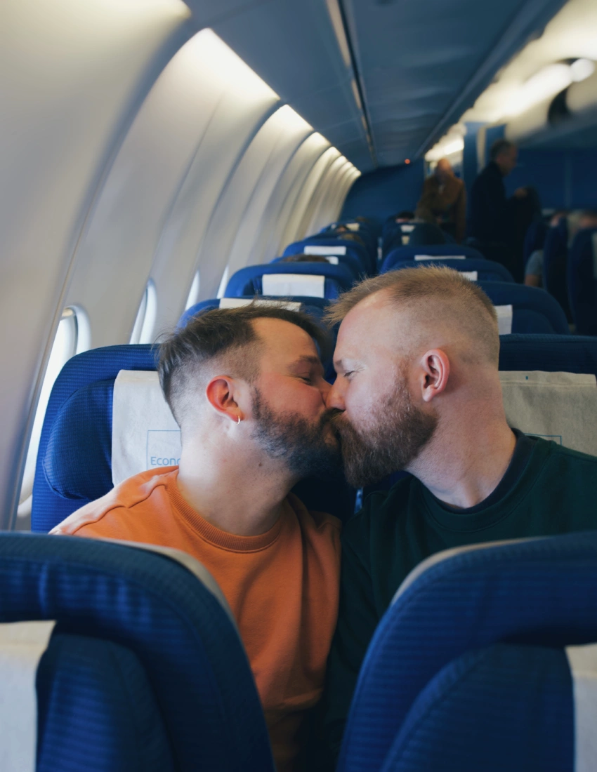 Flying with KLM from Amsterdam to Miami: Gay Couple kiss in Economy Class of KLM flight to Miami © Coupleofmen.com