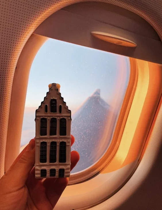 Flying with KLM from Amsterdam to Miami: Good morning view over Amsterdam with the newest miniature Delft Blue house © Coupleofmen.com