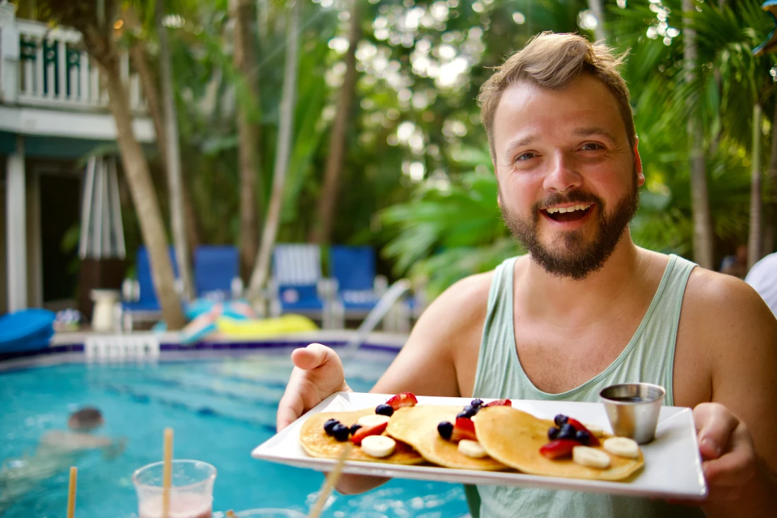 A happy Karl with his Breakfast Pancakes by the Pool © Coupleofmen.com