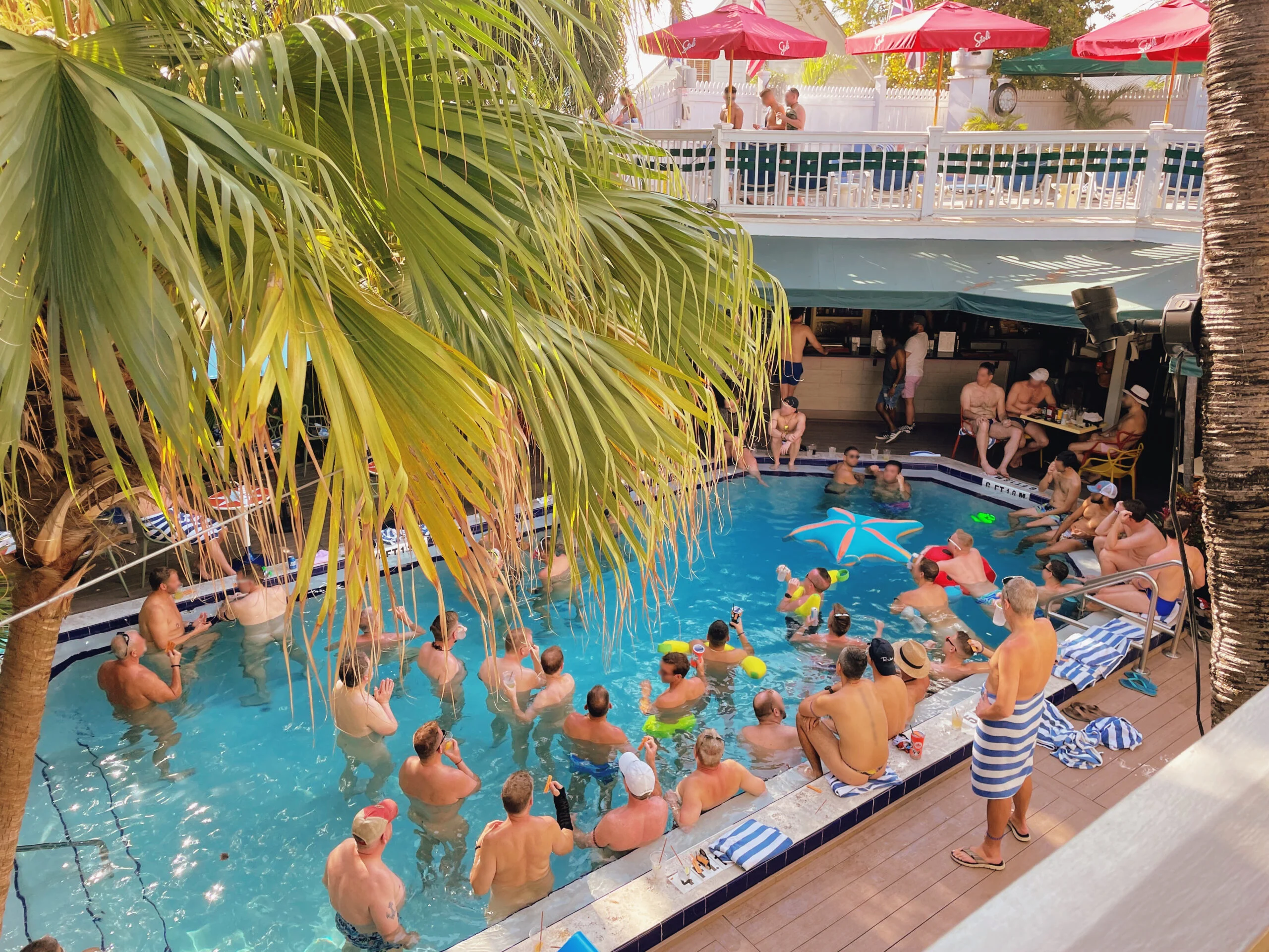 Busy pool with nude men at the Island House - best gay resort in the world © Coupleofmen.com
