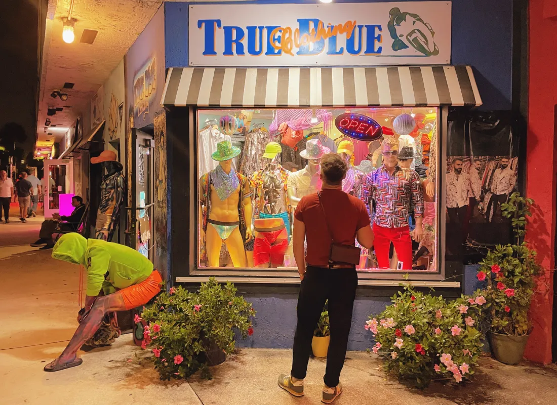 Karl shopping in Wilton Manors looking at the store window of True Blue Clothing © Coupleofmen.com