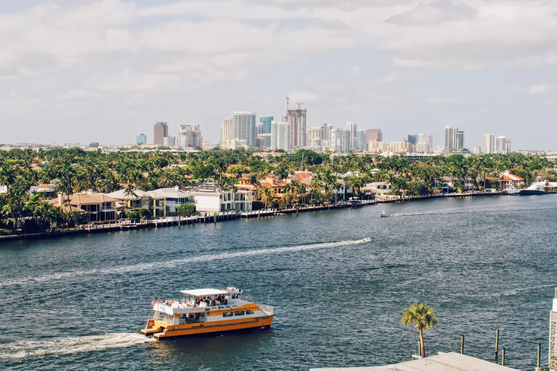 Water Taxi driving on the Intracoastal Waterway with Downtown Fort Lauderdale in the background © Coupleofmen.com