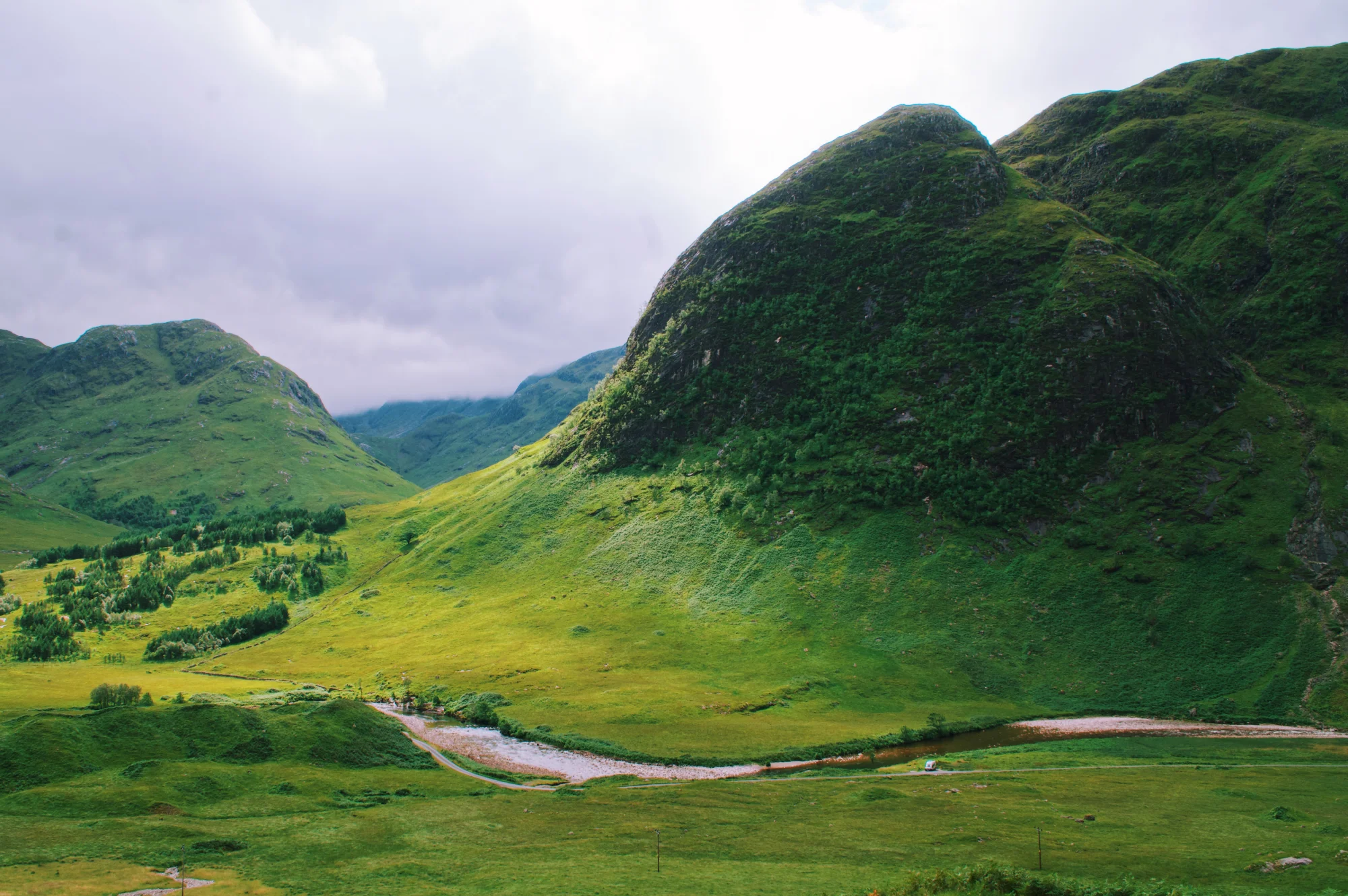 Can you spot our camper van embedded in this beatiful green Scottish Glenn? © Coupleofmen.com