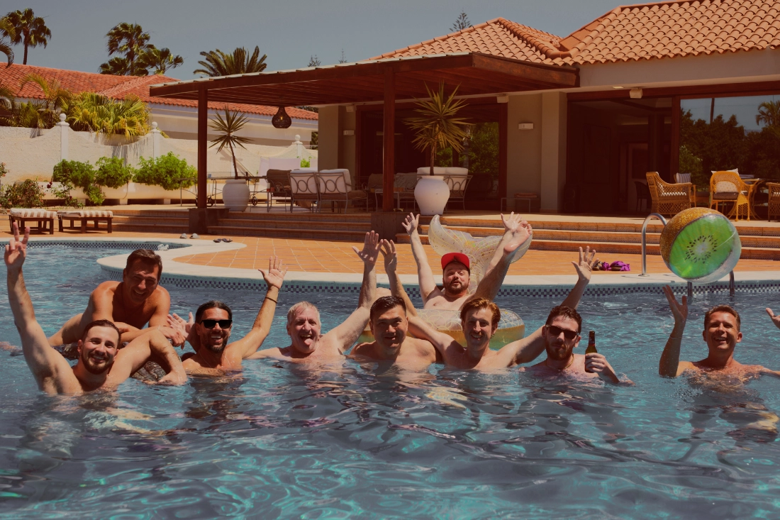 Nine naked men posing for a picture while standing in the pool of the Naked Villa Trip by Everything To Sea on Gran Canaria. Clothing-optional Gay Vacation Gran Canaria