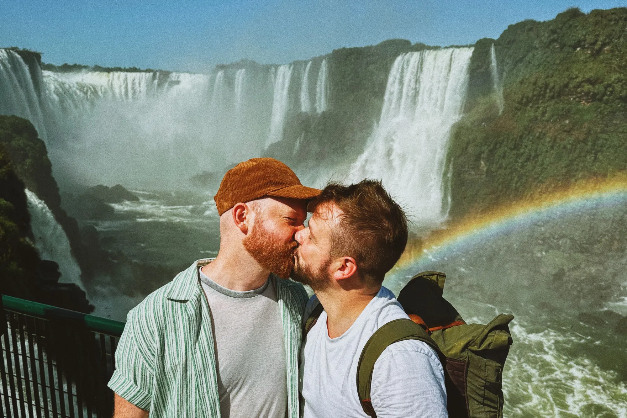 A gay couple kiss at the Devil's Throat Viewpoint of the Iguazu Falls in Brazil © Coupleofmen.com