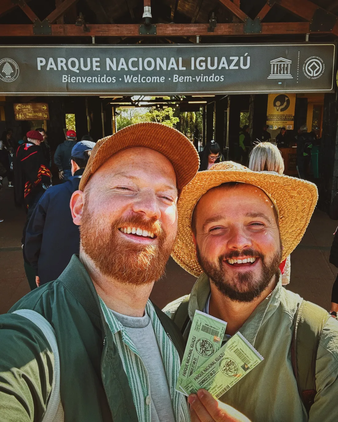 Selfie with tickets at entrance of Parque Nacional Iguazú in Argentina © Coupleofmen.com