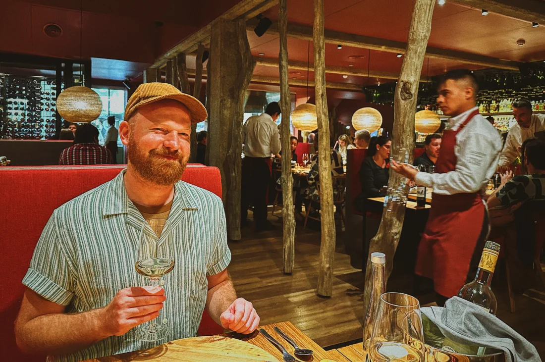 Daan enjoying the wine and the handsome waiters at Mako © Coupleofmen.com