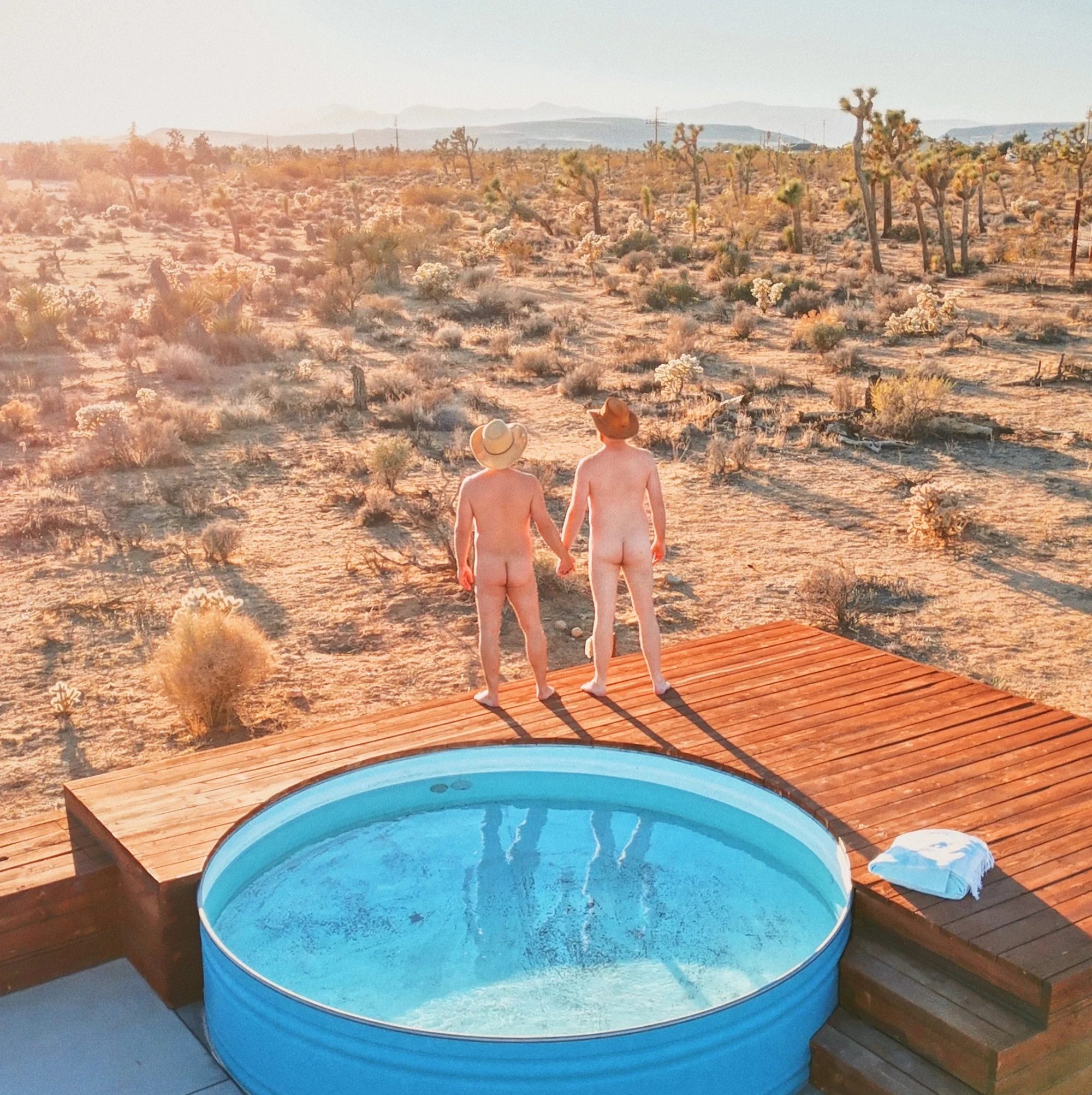 Nude photo of a couple of men hand in hand in Yucca Valley