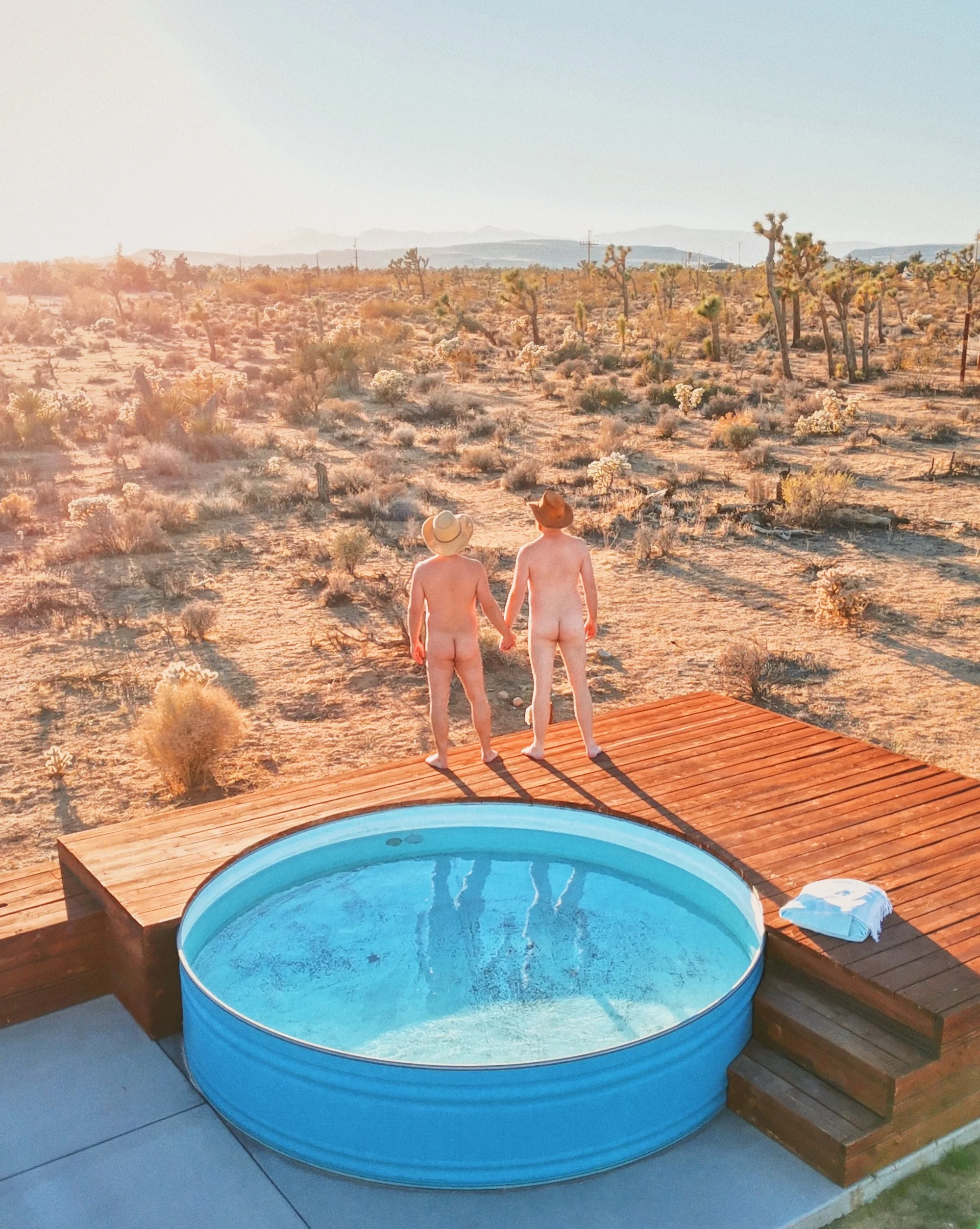 Nude photo of a gay couple of men hand in hand in Yucca Valley © Coupleofmen.com