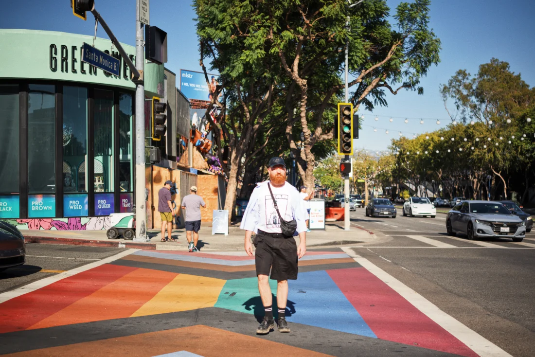 Daan crossing the rainbow crosswalk in West Hollywood © Coupleofmen.com | West Hollywood LGBTQ+ travel guide