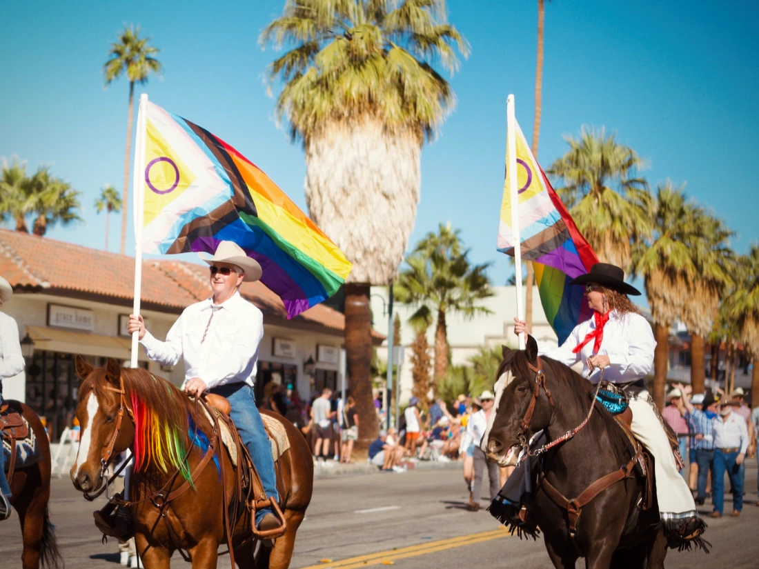 Happy Pride Palm Springs: Participants with progress flags on horses © Coupleofmen.com