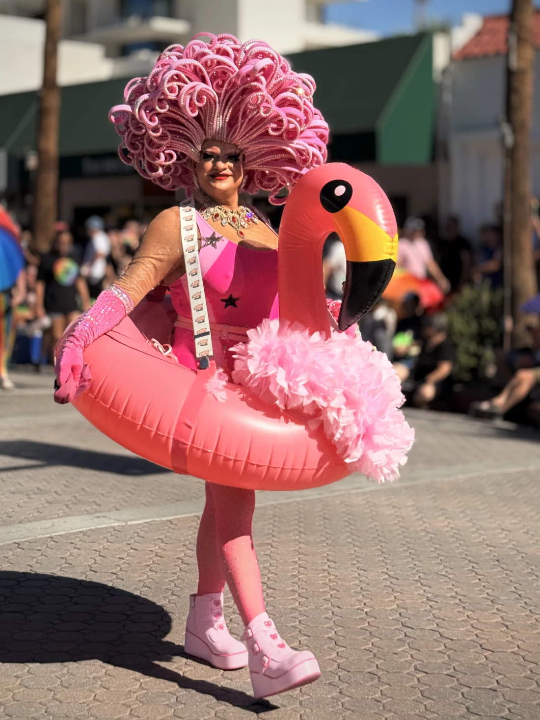 Drag Queen in a Pink flamingo dress walking Palm Springs Pride 2025 © Coupleofmen.com